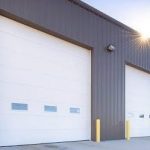 FactorySteelOverstock gray steel building with 2 overhead doors